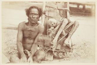 [Seated man with the preserved corpse of his father, New Guinea]   from Oceanic Album