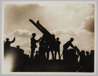 [Gunners loading a gun]