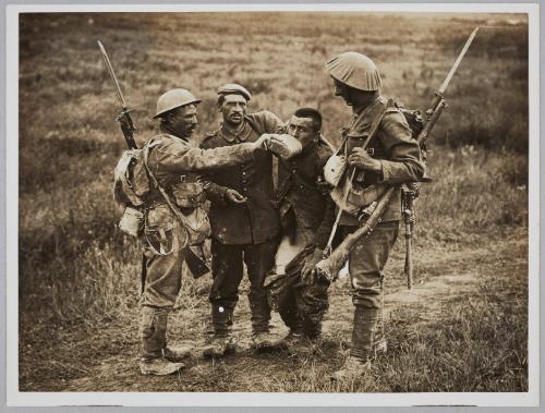 Tommies giving a wounded German a drink