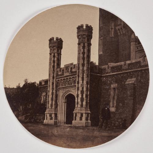 View of an entrance on the façade of the Château de Vallombrosa, Cannes. A man standing to the right.