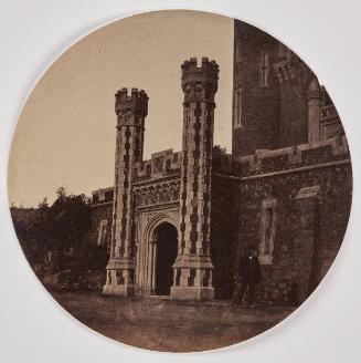 View of an entrance on the façade of the Château de Vallombrosa, Cannes. A man standing to the right.
