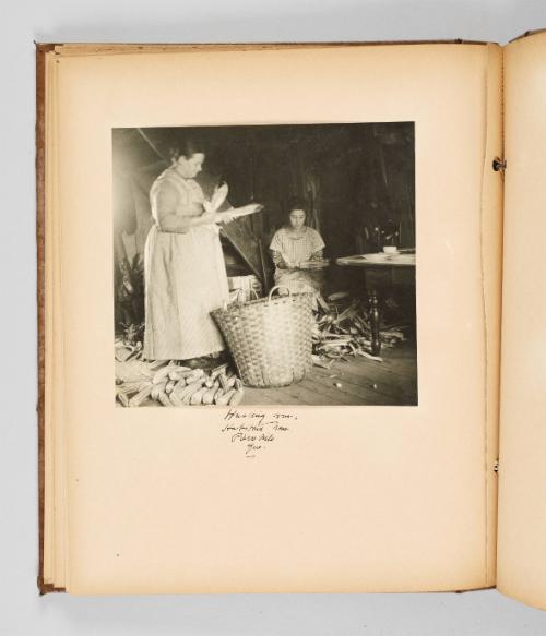 Husking corn, Habitant home, Pierreville, Que. Page 36 of The Abenaki; from collection of Canadian albums compiled by Edith S. Watson, 1890s-1930s