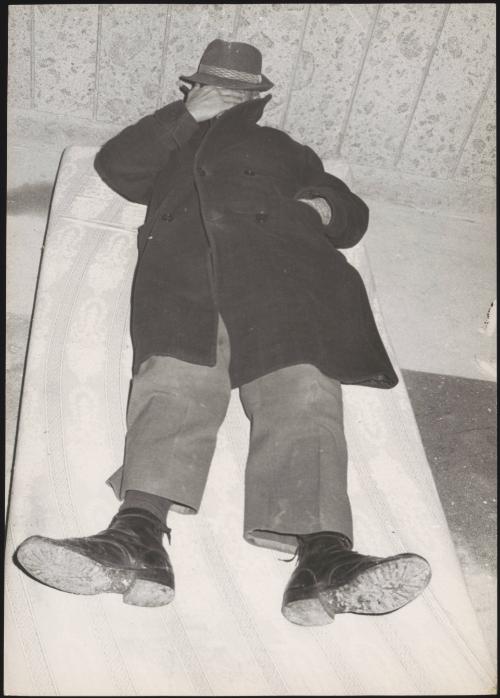 A man lies to rest on a mattress in shelter during the aftermath of an earthquake in Tuscany that left about 5,000 homeless