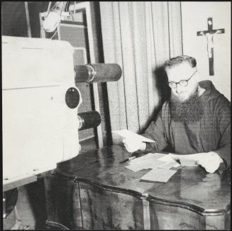 Padre Mariano in a RAI TV studio delivering a religious broadcast