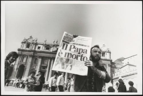 A man holds up a copy of a newspaper with the headline: 'The Pope is dead', in St. Peter's Square, after the death of Pope John Paul I on 28 September 1978