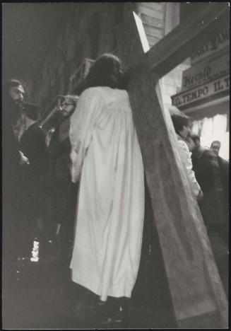 A man re-enacting the Via Crucis in a procession 