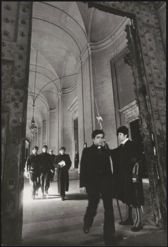 Young men studying to be a part of the church walking through doors at the Vatican City 