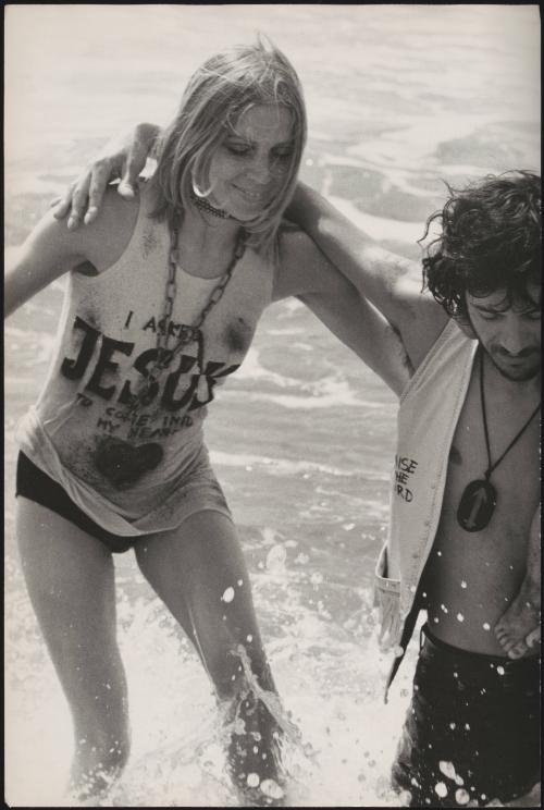 Young, religious hippies at a gathering and baptism at the seashore