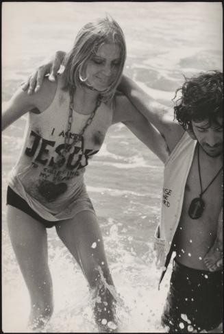Young, religious hippies at a gathering and baptism at the seashore