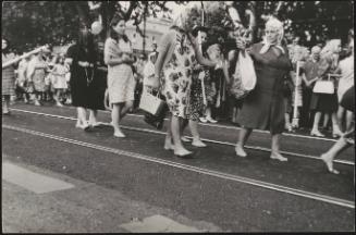 Barefoot women walk in a religious procession in Trastevere, Rome