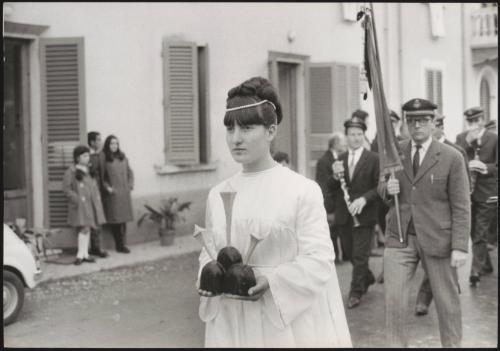 A young woman leads a religious procession 