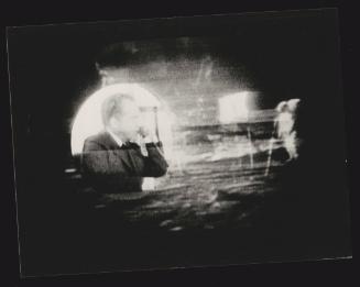 A photograph of the televised Moon Landings and U.S. President Richard Nixon speaking by phone to congratulate the astronauts, 1969