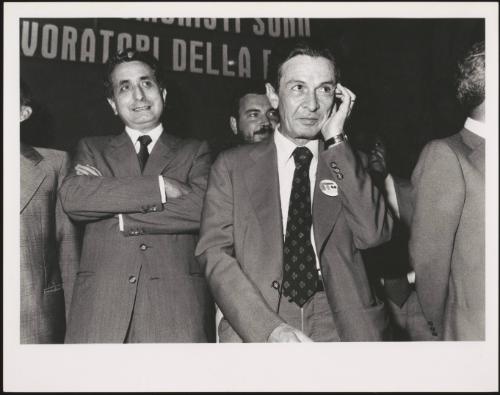 Enrico Berlinguer wears a badge on his jacket at an election event