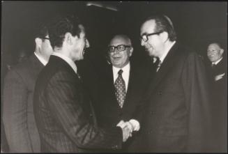 Giulio Andreotti shaking hands with Mariano Rumor and Abdessalam Jalloud