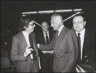 Furio Colombo and Giovanni Agnelli in discussion; Guido Carli can be seen just behind them