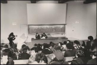 Two speakers are filmed at a conference of the Communist Party Movement in a university