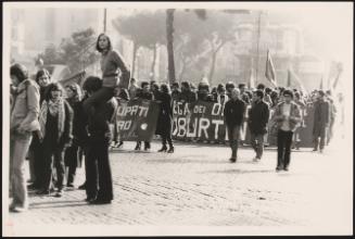 Crowds of students marching as part of a rally through a piazza