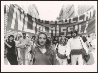 A young woman leading a group at an anti-nuclear march