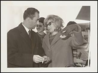 Film director Michelangelo Antonioni with Monica Vitti at the Ippodromo Roma Capannelle for a horse race in 1962