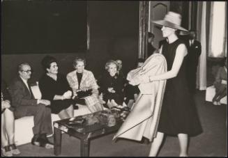 Josip Tito with his wife Jovanka Broz watch a fashion show