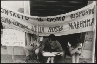 Montalto di Castro, people sit under protest banners

