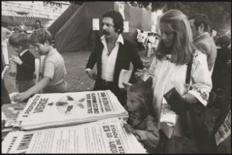 People picking up posters at a demonstration for a greener world