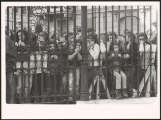 People mourning at The Great Synagogue of Rome's railings after a terrorist attack