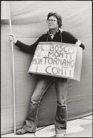 A man with a hand written protest placard 