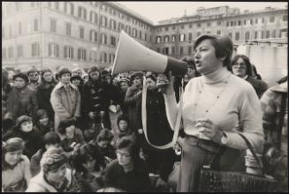 Maria Magnani Noya of the Italian Socialist Party (PSI) speaking to a crowd through a megaphone