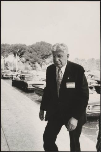 Arthur Frank Burns walking up steps from the road