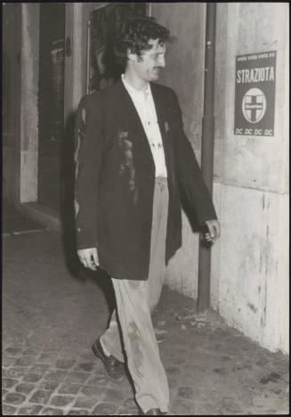 Demostrator walks past a DC poster