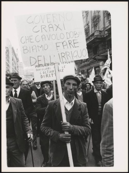 Demonstrators hold placards at a protest by agricultural workers