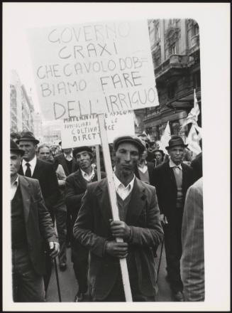 Demonstrators hold placards at a protest by agricultural workers