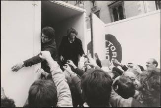 Farmer's handing out milk from the back of milk trucks during an agriculture demonstration