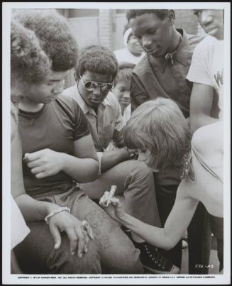 Jane Fonda signing autographs on fans' jeans during the filming of 'Klute'