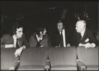 The actor and director Vittorio De Sica sitting in a cinema with his son Christian (far left) 