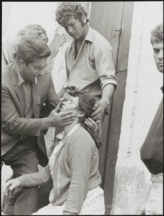 Filicudi residents sheltered in Lipari aid a woman who has fallen ill