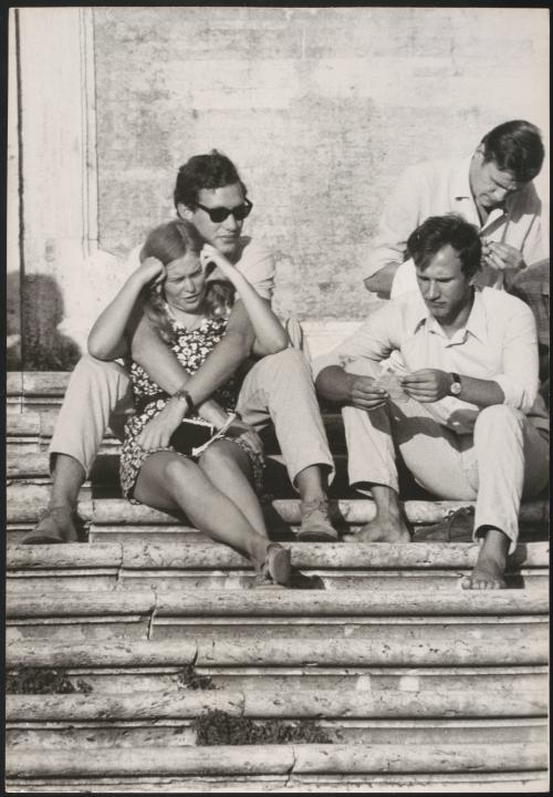 An Italian 'Pappagalli' man relaxing with his female tourist on the Spanish Steps, Rome
