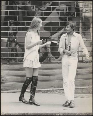 An Italian 'Pappagalli' man approaches a female tourist in the street