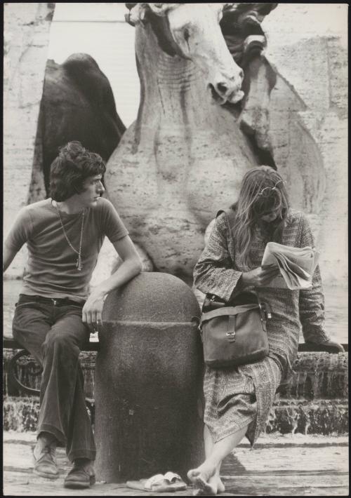 An Italian 'Pappagalli' man tries to talk to a female tourist in Piazza Navona, Rome
