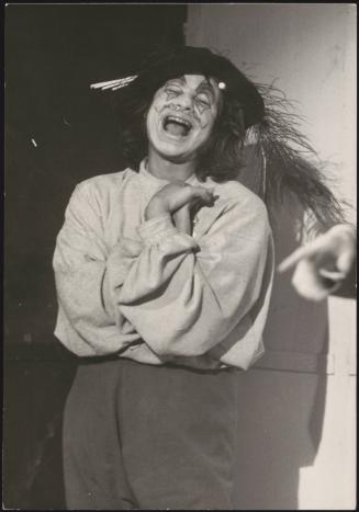 A young man dressed in theatrical costume