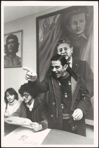 A speaker at a PCI meeting, under portraits of Che Guevara and Gramsci, in the Tor de Schiavi district, Rome