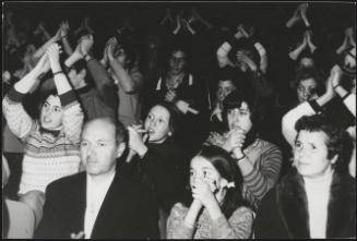 A crowd applauds at a Communion and Liberation demonstration