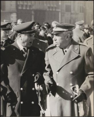 Two officers in the Italian Army walking in a crowd