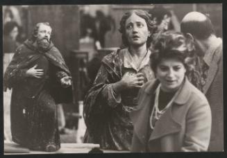 A market scene showing religious statues for sale