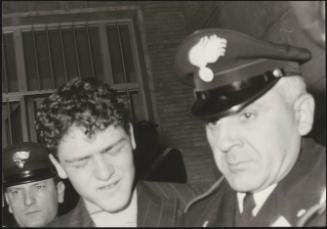 Plane hijacker Raffaele Minichiello escorted by policemen 