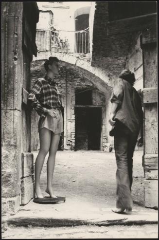 A man and a mannequin on a street in Spoleto, Italy