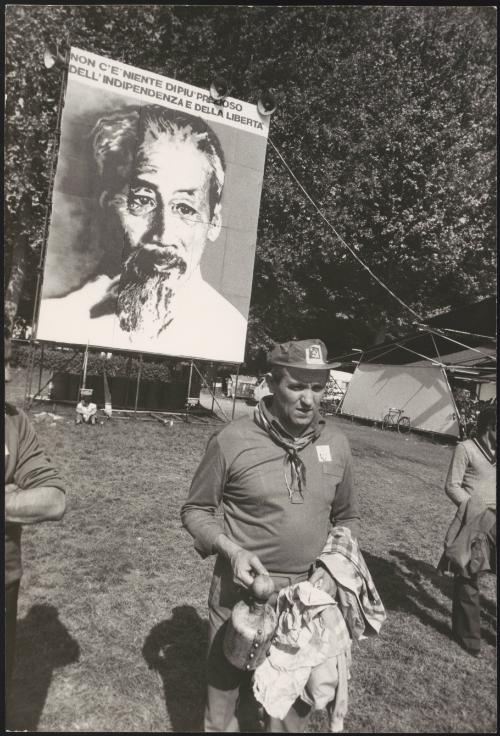 At a festival in Modena, in the Emilia-Romagna region of Italy, men stand beneath a banner of Hồ Chí Minh that reads 'There is nothing more precious than independence and freedom'