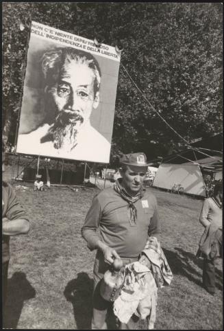 At a festival in Modena, in the Emilia-Romagna region of Italy, men stand beneath a banner of Hồ Chí Minh that reads 'There is nothing more precious than independence and freedom'
