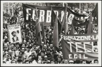 Large crowds gather at a Communist Party rally, including members of the trade union CGIL
